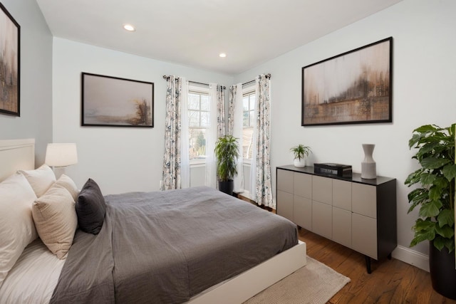 bedroom with recessed lighting, baseboards, and wood finished floors