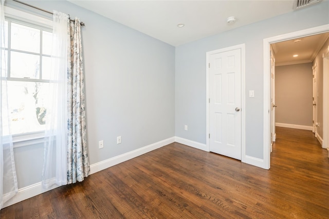 unfurnished room with dark wood-style floors, recessed lighting, visible vents, and baseboards