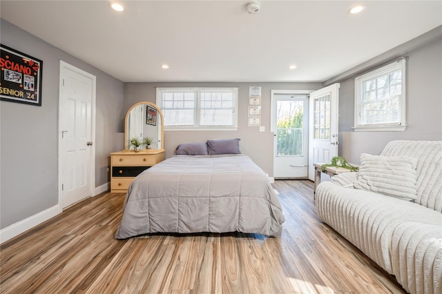 bedroom featuring light wood-type flooring, access to exterior, baseboards, and recessed lighting