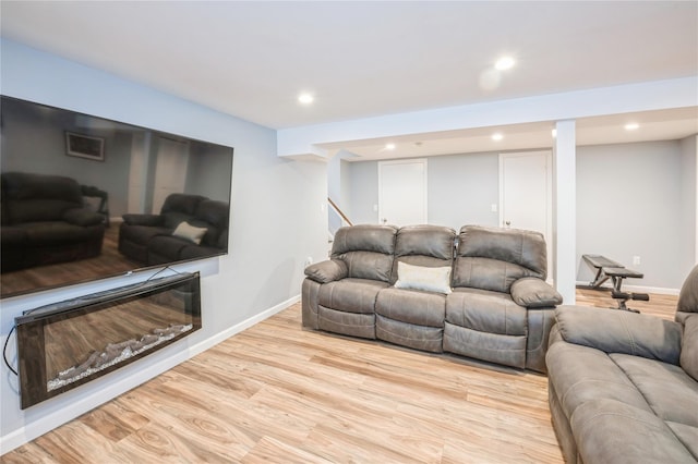 living area with baseboards, wood finished floors, and recessed lighting