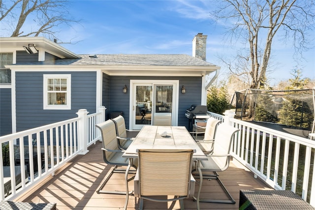 wooden terrace with grilling area and outdoor dining area