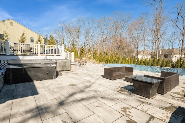 view of patio featuring outdoor lounge area, a hot tub, and a wooden deck