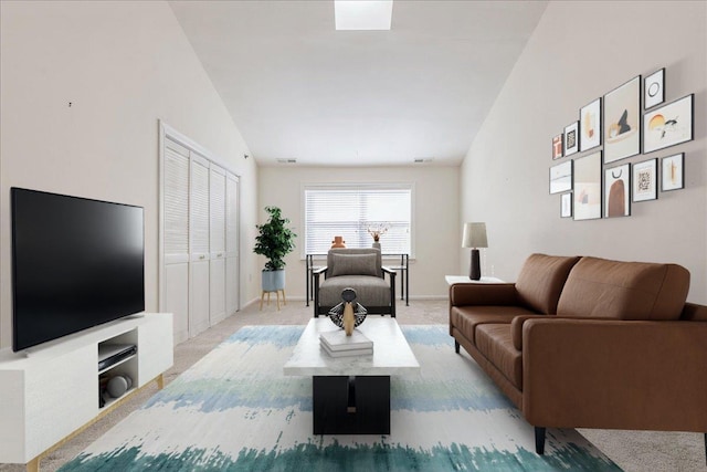 carpeted living room featuring vaulted ceiling