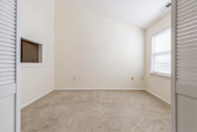 unfurnished room featuring light colored carpet