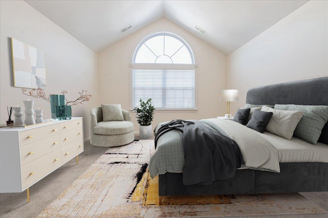 carpeted bedroom with lofted ceiling