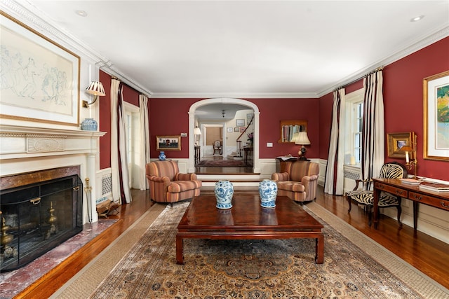 133AKA139 Hampshire Rd, Bronxville, NY 10708 - living room featuring wood finished floors, arched walkways, ornamental molding, a fireplace with flush hearth, and stairs