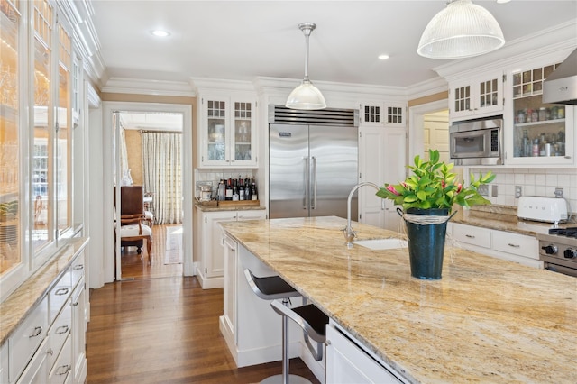 133AKA139 Hampshire Rd, Bronxville, NY 10708 - kitchen featuring built in appliances, a sink, tasteful backsplash, white cabinets, and ornamental molding