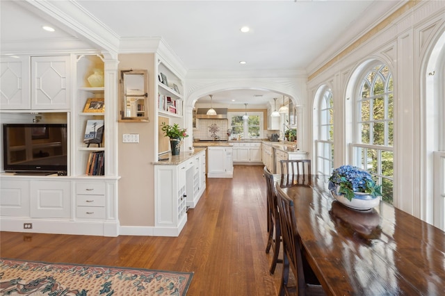 133AKA139 Hampshire Rd, Bronxville, NY 10708 - dining space with wood finished floors, arched walkways, crown molding, and recessed lighting