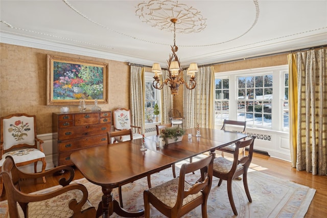 133AKA139 Hampshire Rd, Bronxville, NY 10708 - dining area with a chandelier, plenty of natural light, light wood-style flooring, and ornamental molding