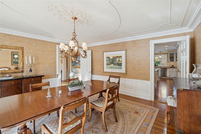 133AKA139 Hampshire Rd, Bronxville, NY 10708 - dining room with a chandelier, ornamental molding, wood finished floors, wainscoting, and wallpapered walls