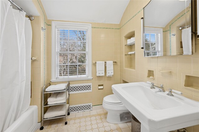 133AKA139 Hampshire Rd, Bronxville, NY 10708 - full bath with toilet, tile walls, plenty of natural light, vaulted ceiling, and shower / bath combo with shower curtain