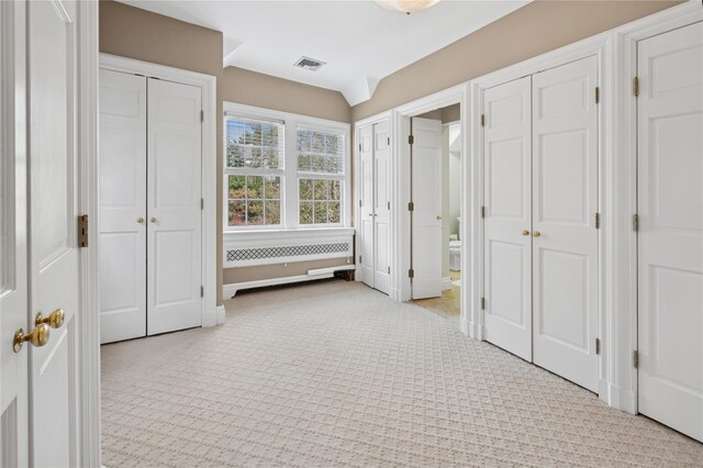 133AKA139 Hampshire Rd, Bronxville, NY 10708 - unfurnished bedroom with light carpet, multiple closets, ensuite bath, and radiator