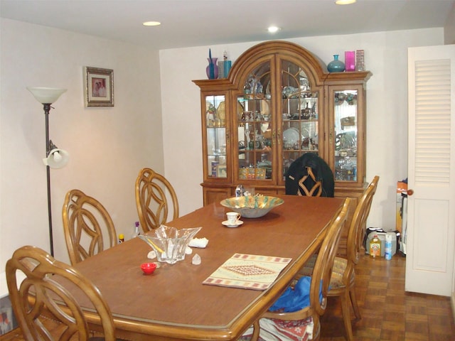 dining room featuring dark parquet flooring