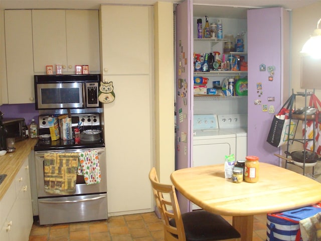 kitchen featuring stainless steel appliances and washing machine and clothes dryer