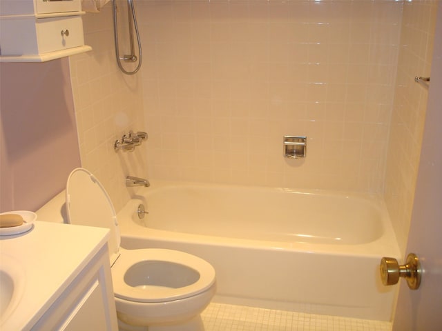 full bathroom featuring tile patterned flooring, vanity, tiled shower / bath combo, and toilet