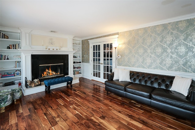 living room with french doors, dark hardwood / wood-style flooring, built in shelves, and ornamental molding