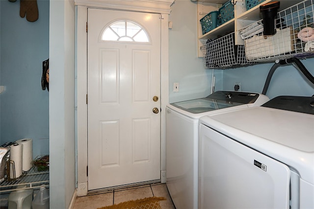 washroom featuring light tile patterned floors and washer and clothes dryer