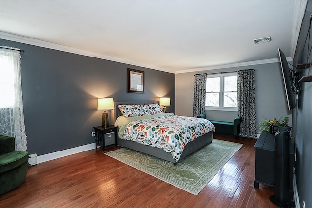 bedroom with crown molding and dark hardwood / wood-style flooring