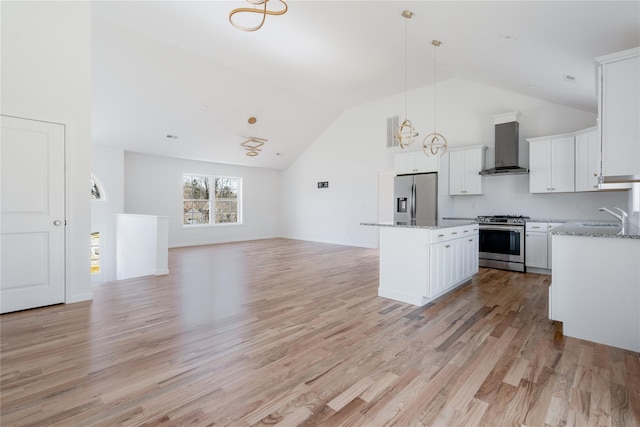 kitchen featuring white cabinetry, a center island, appliances with stainless steel finishes, wall chimney exhaust hood, and pendant lighting