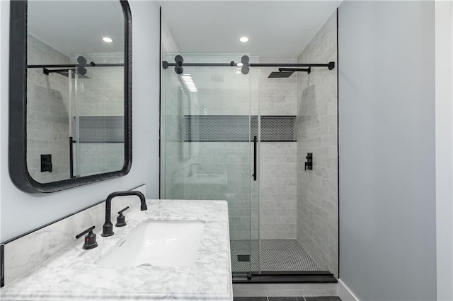 bathroom with an enclosed shower and vanity