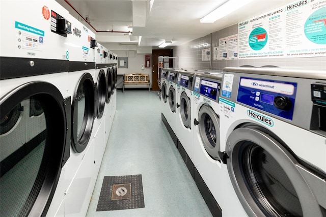 common laundry area with tile patterned floors and washer and clothes dryer