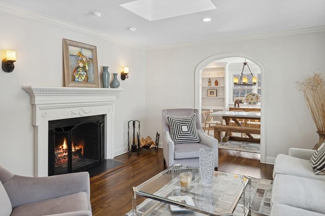 living room with ornamental molding and dark wood finished floors