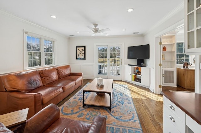 living room featuring ornamental molding, recessed lighting, and light wood finished floors