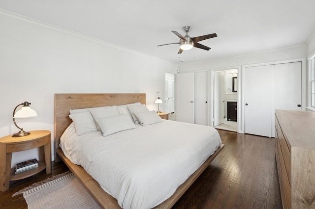 bedroom featuring ensuite bathroom, dark wood-style flooring, a ceiling fan, and crown molding