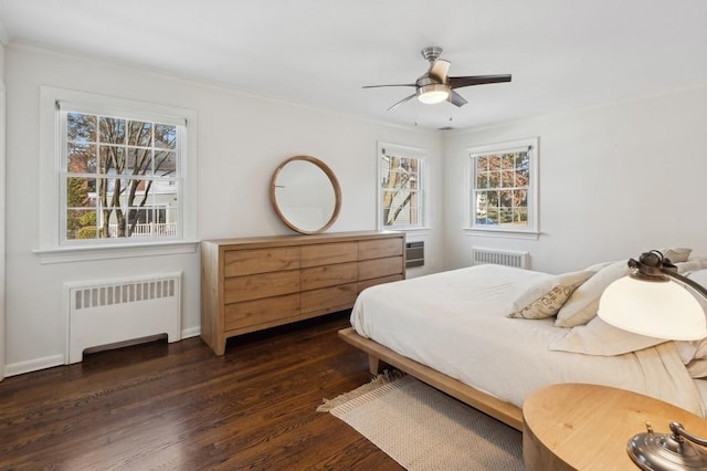 bedroom featuring crown molding, ceiling fan, dark wood-type flooring, and radiator