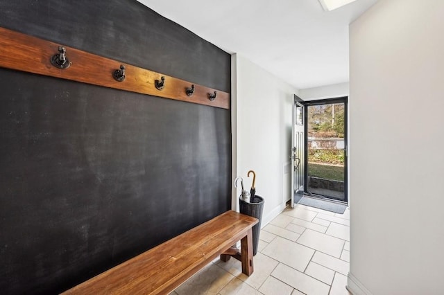 mudroom featuring light tile patterned floors and baseboards