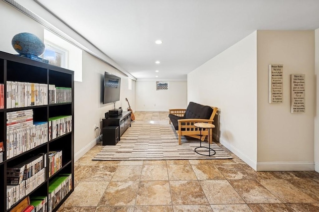 living area with stone finish flooring, baseboards, and recessed lighting