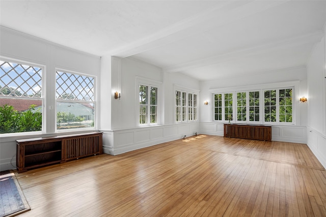 unfurnished sunroom with radiator heating unit, beamed ceiling, and radiator