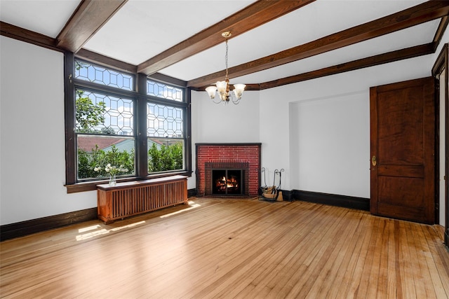 unfurnished living room with light wood-type flooring, radiator heating unit, a fireplace, and baseboards