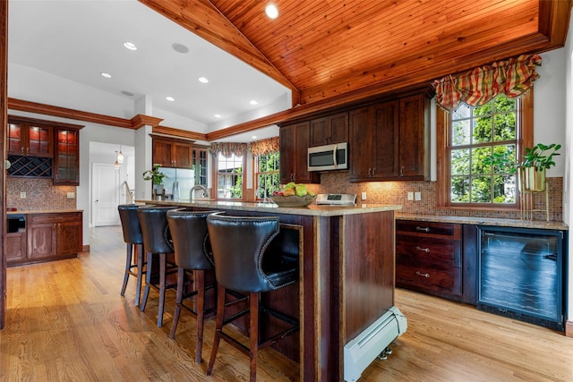 kitchen featuring a baseboard heating unit, wood ceiling, appliances with stainless steel finishes, and light wood-style floors