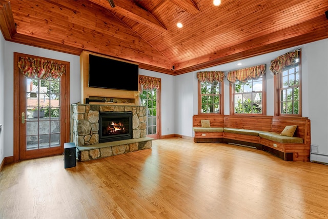 living area featuring a wealth of natural light, wood ceiling, a fireplace, and wood finished floors