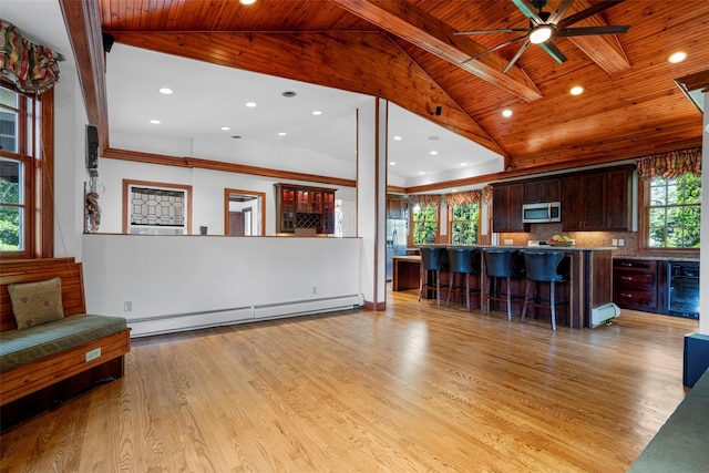 living area featuring a baseboard heating unit, light wood finished floors, lofted ceiling with beams, and wooden ceiling