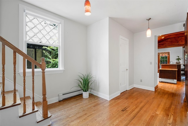 entryway featuring light wood-style floors, a baseboard radiator, and baseboards