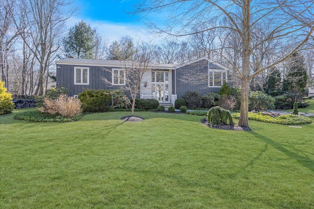 view of front of home with a chimney and a front lawn