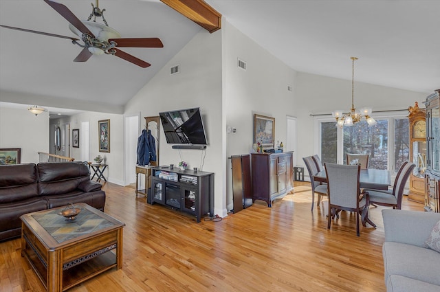 living area featuring visible vents, high vaulted ceiling, beam ceiling, light wood-style floors, and ceiling fan with notable chandelier