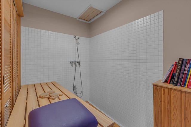bathroom with tiled shower
