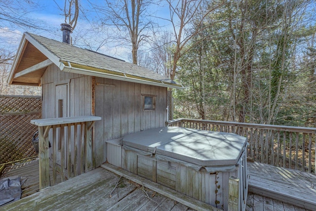wooden terrace featuring a covered hot tub