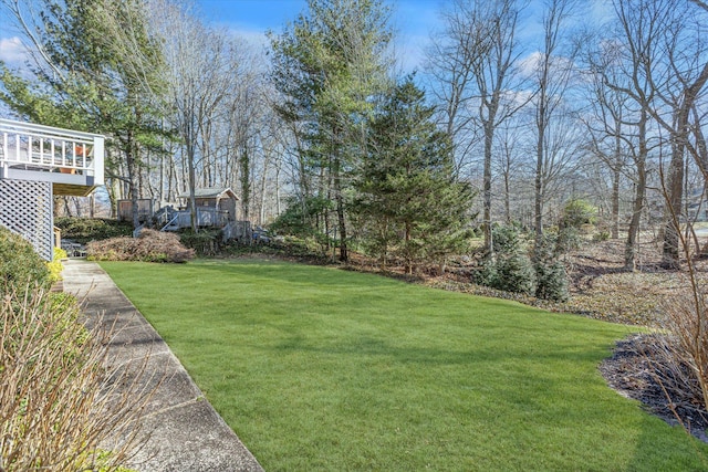 view of yard with a wooden deck