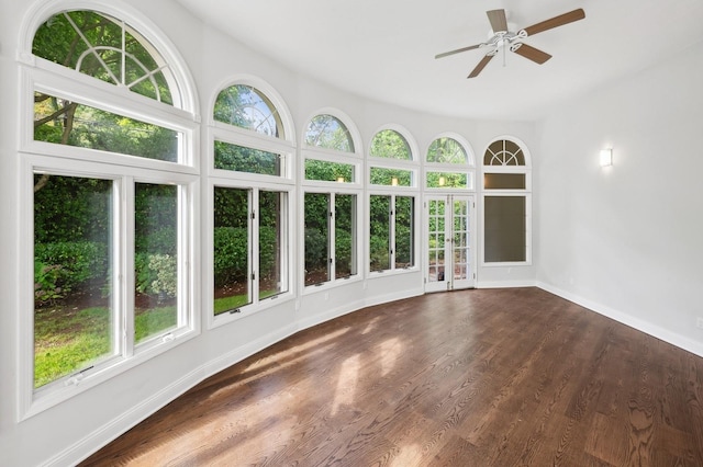 unfurnished sunroom featuring ceiling fan