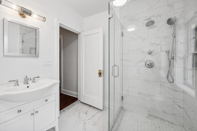 bathroom featuring vanity and a shower with door