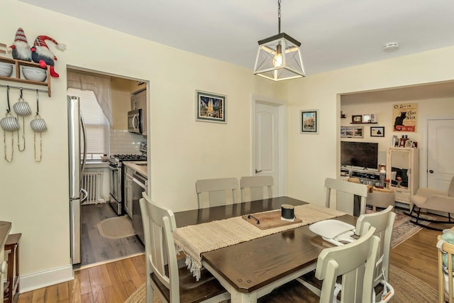 dining area with wood finished floors