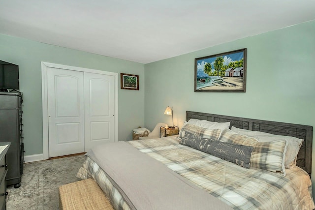 bedroom with a closet and baseboards