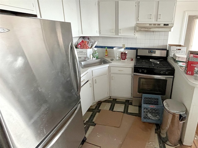 kitchen featuring decorative backsplash, sink, stainless steel appliances, and white cabinets