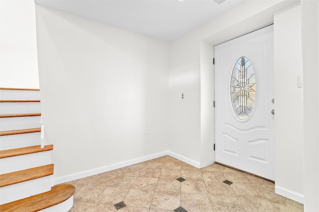 entrance foyer with baseboards and stairs