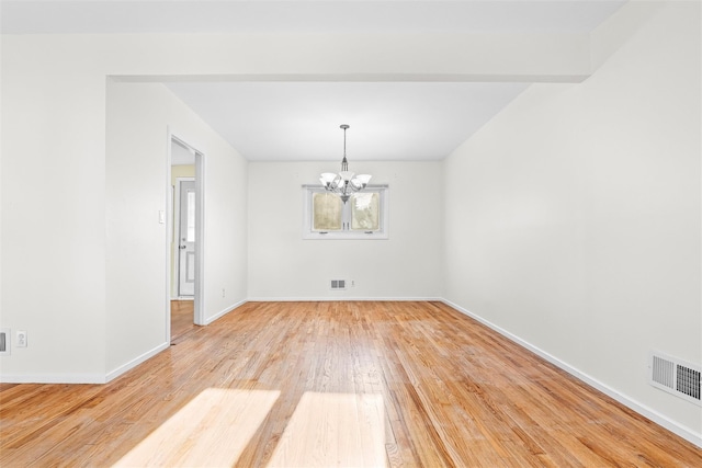 interior space with a notable chandelier, baseboards, visible vents, and light wood-style floors