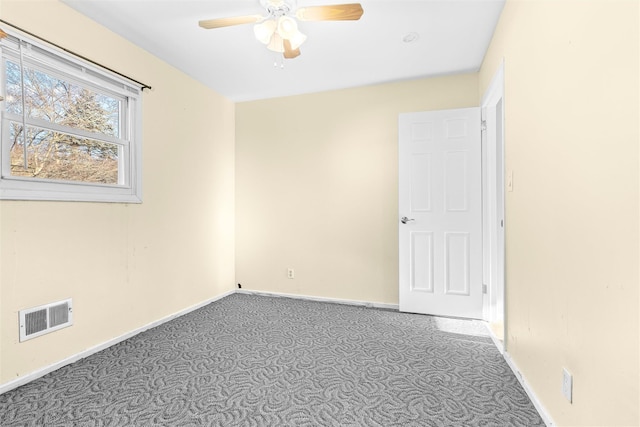 spare room with a ceiling fan, carpet, visible vents, and baseboards